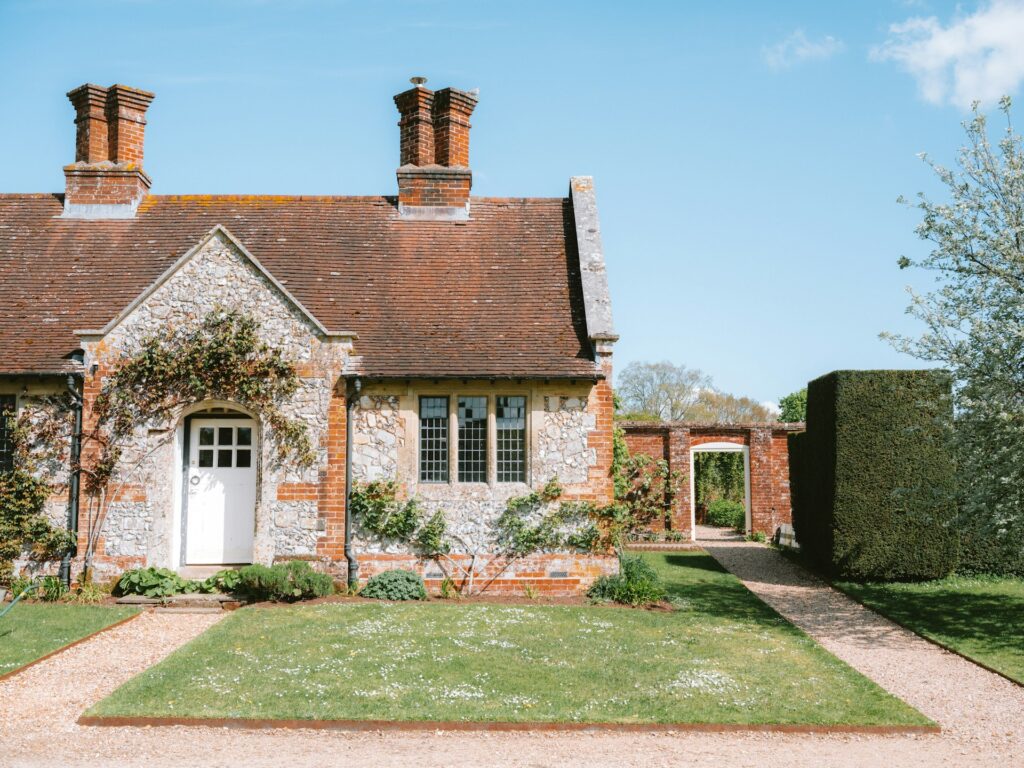 Charming stone cottage with garden path and blue sky