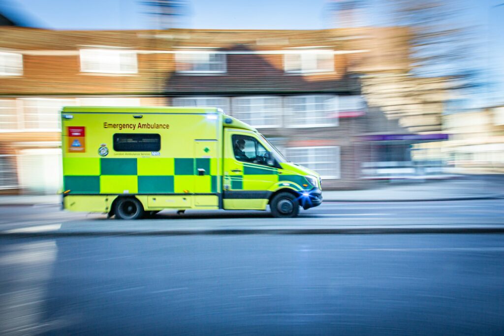 NHS emergency ambulance responding on a UK street