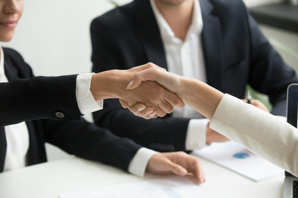 Solicitor and client shaking hands over a property purchase