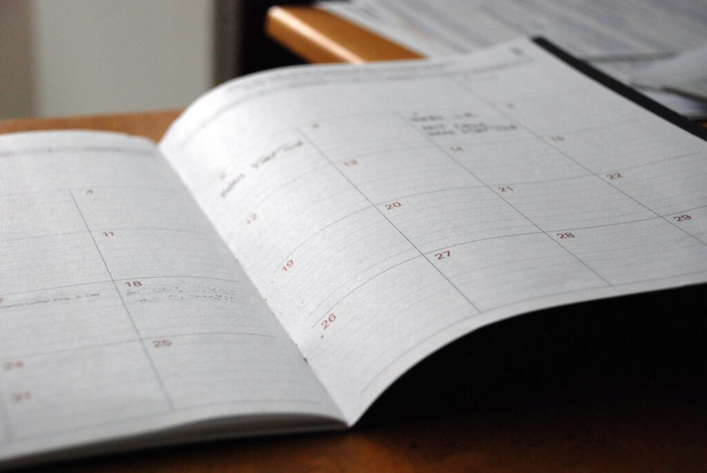 open monthly planner on wooden desk